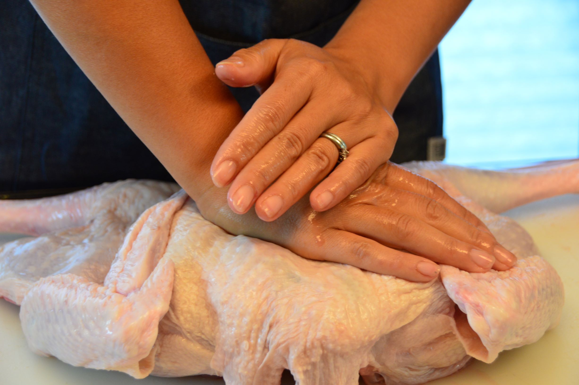 Flatten the turkey by pushing on breasts to break the breast bone