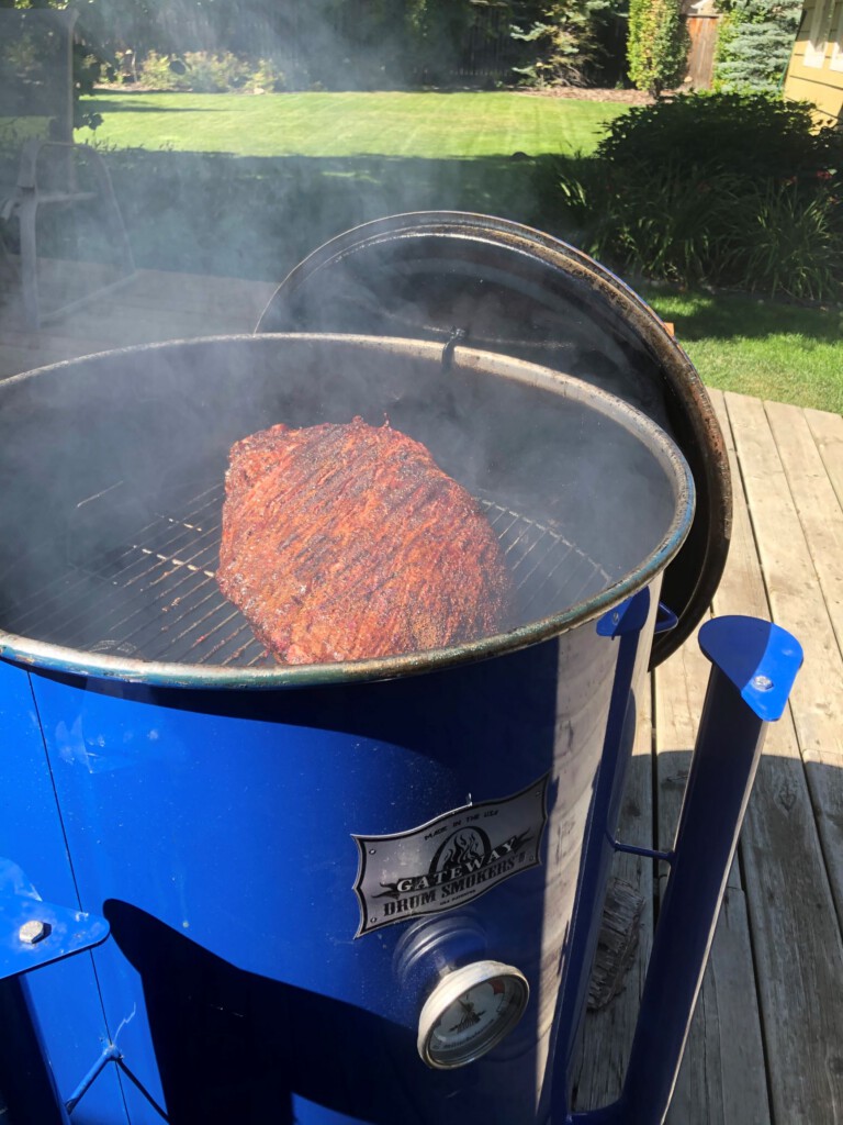 Whole brisket cooking on BBQ/ Smoker